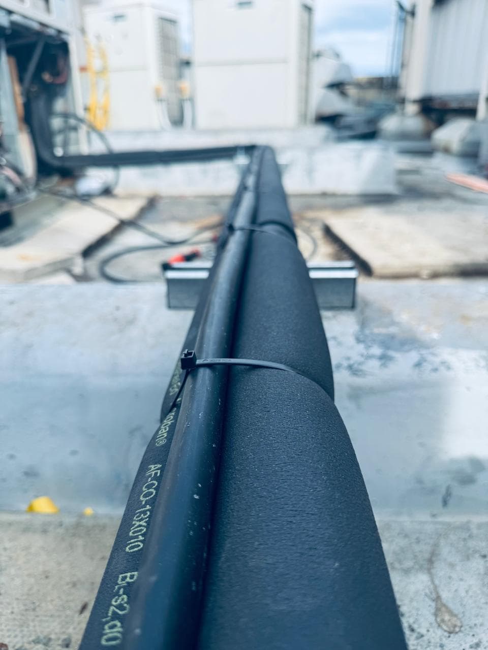 Insulated refrigerant pipework on a rooftop plant installation
